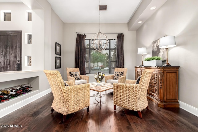 sitting room featuring a chandelier, dark wood-style floors, visible vents, and baseboards