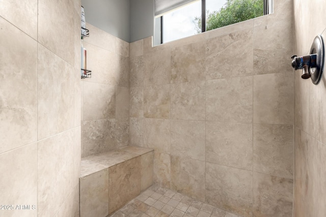 bathroom with a tile shower