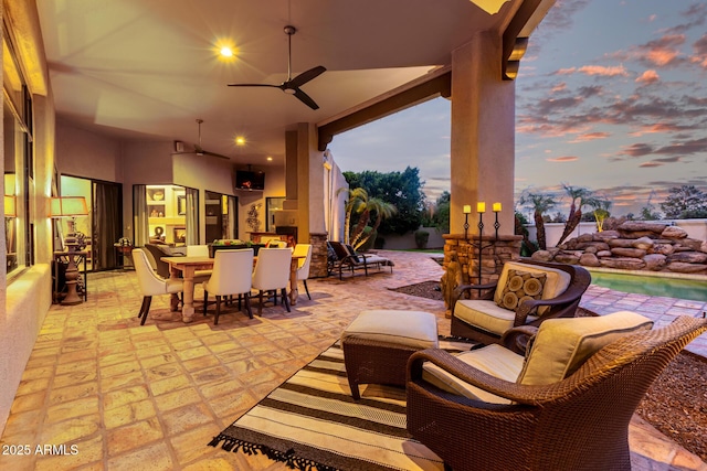 view of patio with outdoor dining space, an outdoor living space, and ceiling fan