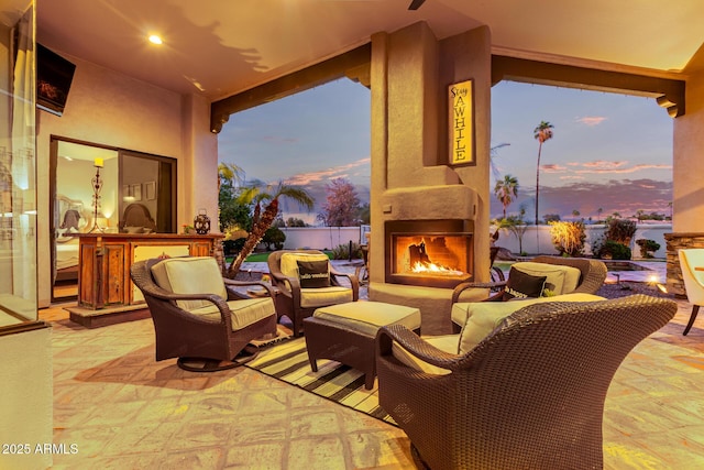 view of patio with an outdoor living space with a fireplace