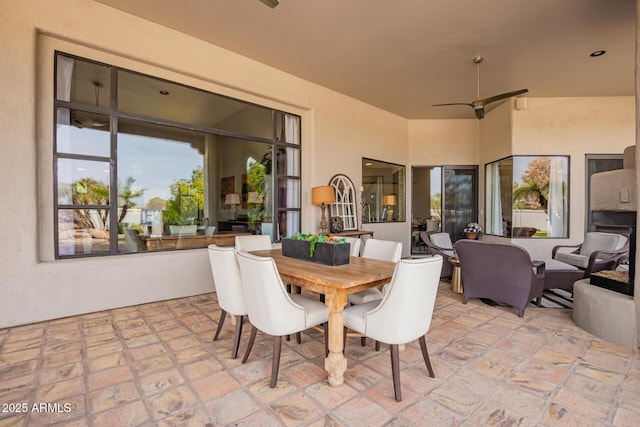 view of patio featuring outdoor dining space and ceiling fan