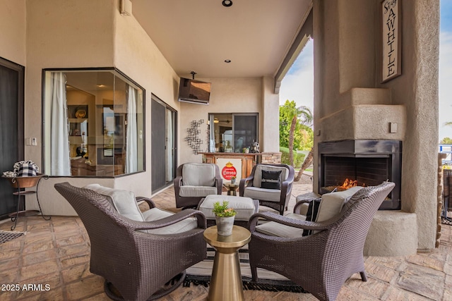 view of patio / terrace featuring an outdoor living space with a fireplace