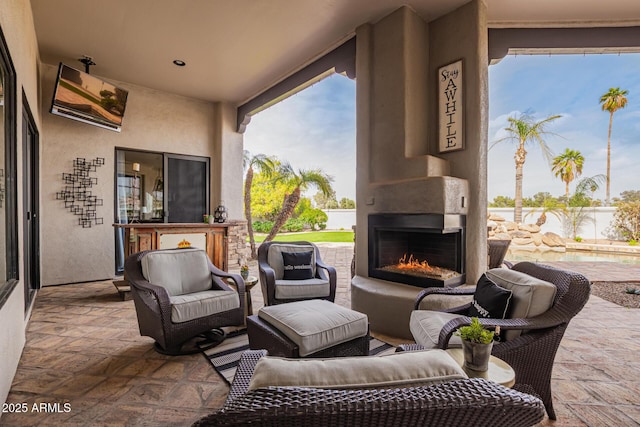 view of patio featuring a large fireplace