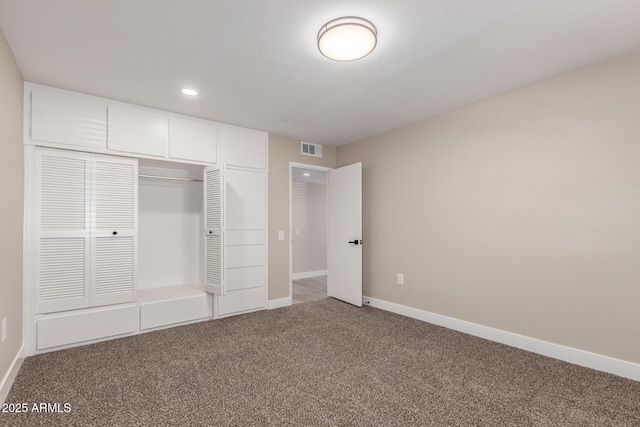 unfurnished bedroom featuring a closet and carpet flooring