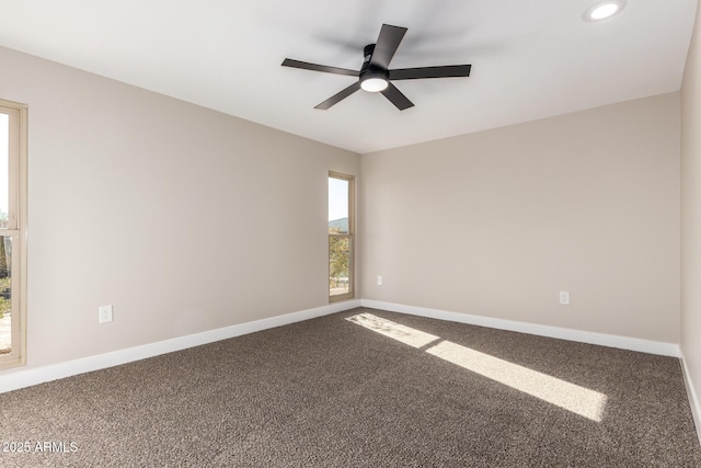 carpeted empty room featuring ceiling fan