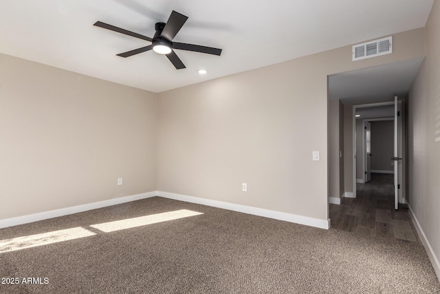 carpeted spare room with ceiling fan