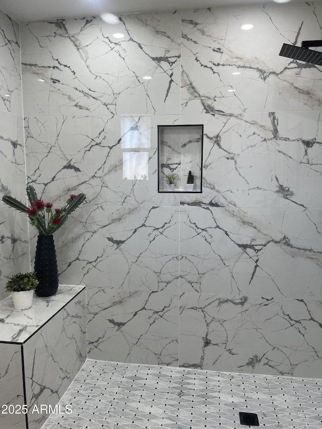 full bathroom with a marble finish shower