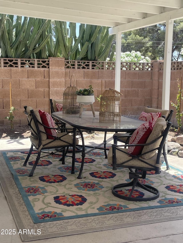 view of patio / terrace with outdoor dining space and fence