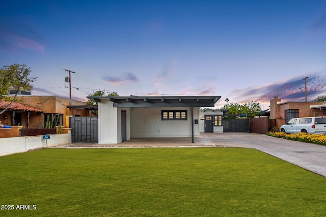 view of front of house with a yard and a carport