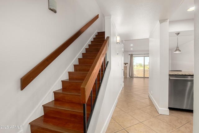 stairs featuring tile patterned flooring