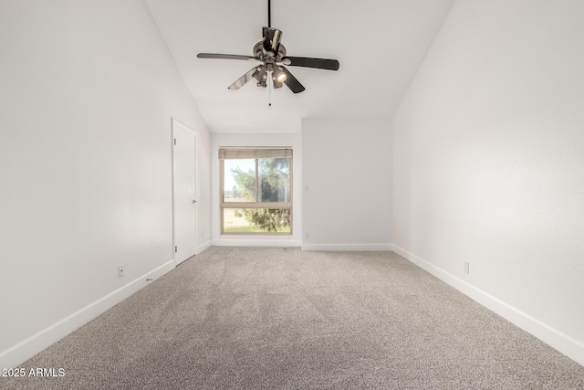 empty room featuring lofted ceiling, carpet, and ceiling fan