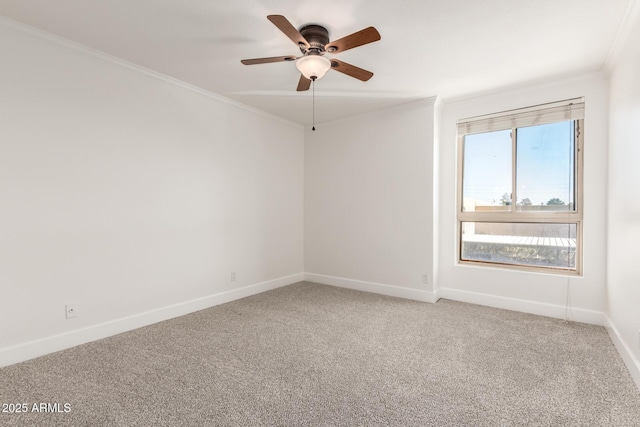 carpeted empty room with crown molding and ceiling fan