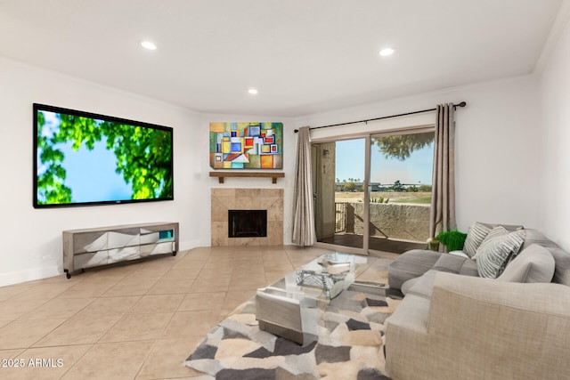 tiled living room with ornamental molding and a tile fireplace