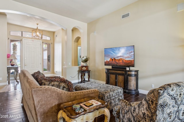6428 W Eugie Ave, Glendale, AZ 85304 - living room with dark wood-style flooring, arched walkways, a chandelier, and baseboards
