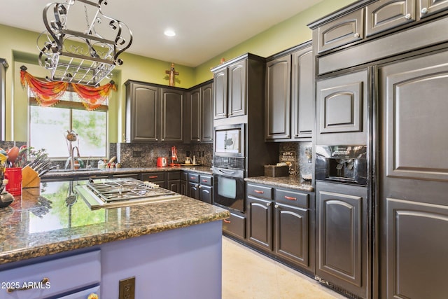 6428 W Eugie Ave, Glendale, AZ 85304 - kitchen featuring stainless steel gas stovetop, tasteful backsplash, a sink, paneled built in refrigerator, and recessed lighting