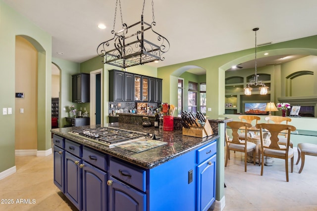 6428 W Eugie Ave, Glendale, AZ 85304 - kitchen with stainless steel gas cooktop, arched walkways, pendant lighting, baseboards, and recessed lighting