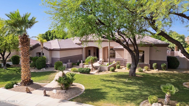 6428 W Eugie Ave, Glendale, AZ 85304 - view of front of property with stucco siding, a front yard, and a tile roof
