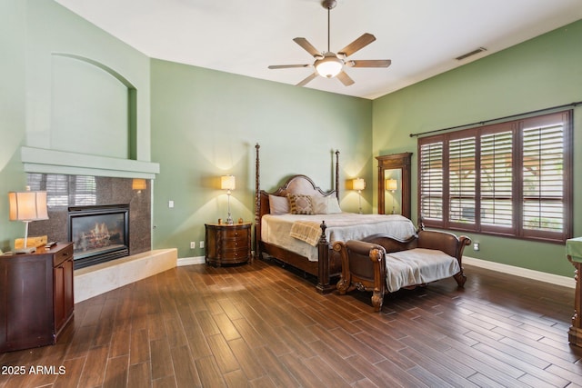 6428 W Eugie Ave, Glendale, AZ 85304 - bedroom with dark wood-style flooring, baseboards, a fireplace, and a ceiling fan