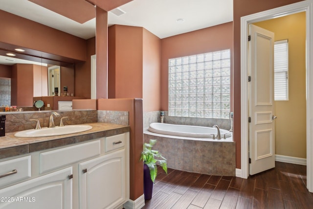6428 W Eugie Ave, Glendale, AZ 85304 - bathroom featuring a bath, wood finished floors, vanity, and baseboards