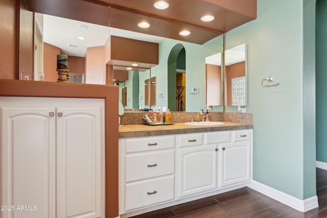 6428 W Eugie Ave, Glendale, AZ 85304 - bathroom featuring baseboards, wood finished floors, and vanity