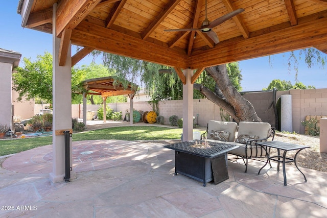 6428 W Eugie Ave, Glendale, AZ 85304 - fenced backyard with ceiling fan, a gazebo, a patio area, and an outdoor living space with a fire pit