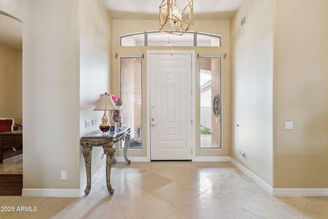 6428 W Eugie Ave, Glendale, AZ 85304 - entryway with tile patterned floors, a chandelier, arched walkways, and baseboards