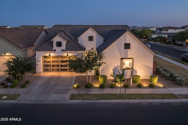 10127 E Tillman Ave, Mesa, AZ 85212 - view of front of home featuring stucco siding, driveway, an attached garage, and a residential view