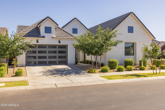 10127 E Tillman Ave, Mesa, AZ 85212 - view of front facade featuring concrete driveway, stucco siding, an attached garage, and a tiled roof