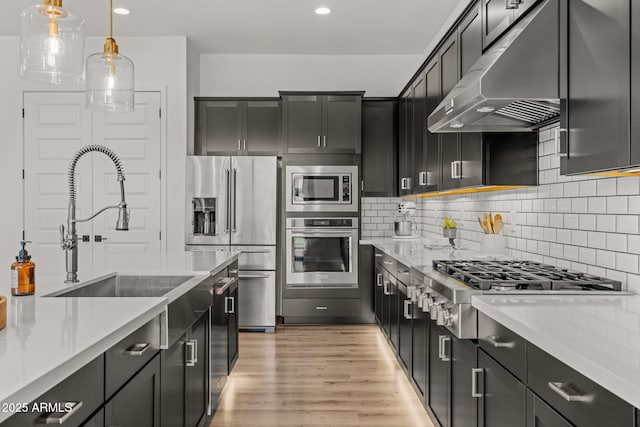 10127 E Tillman Ave, Mesa, AZ 85212 - kitchen with stainless steel appliances, range hood, a sink, light countertops, and recessed lighting
