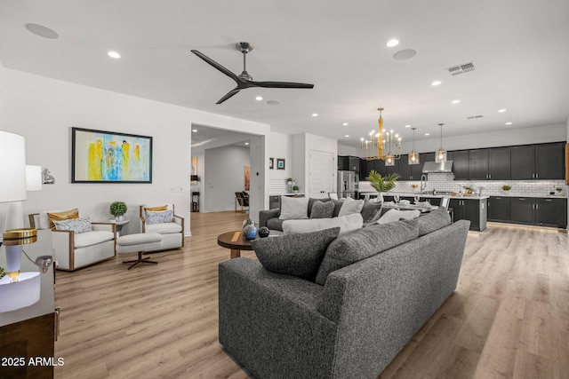 10127 E Tillman Ave, Mesa, AZ 85212 - living room with recessed lighting, a ceiling fan, light wood-style floors, and a chandelier