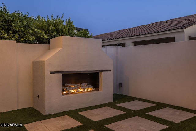 10127 E Tillman Ave, Mesa, AZ 85212 - view of patio / terrace featuring a warm lit fireplace and fence
