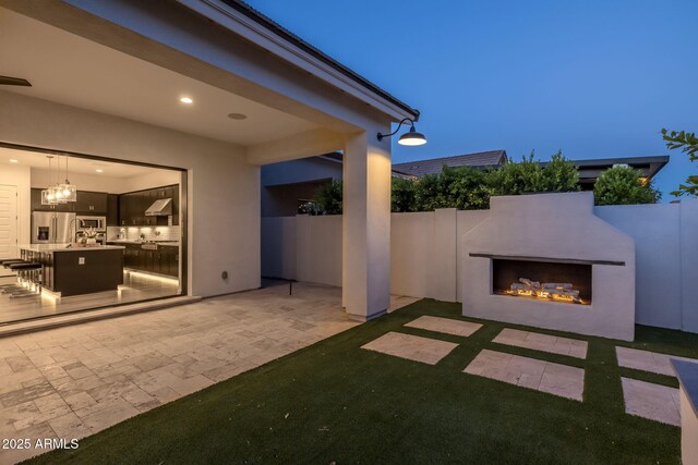 10127 E Tillman Ave, Mesa, AZ 85212 - view of patio with a warm lit fireplace and fence