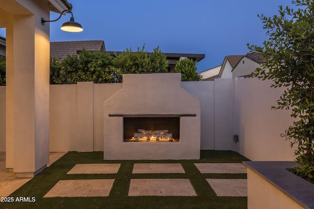 10127 E Tillman Ave, Mesa, AZ 85212 - view of patio / terrace featuring a lit fireplace and fence