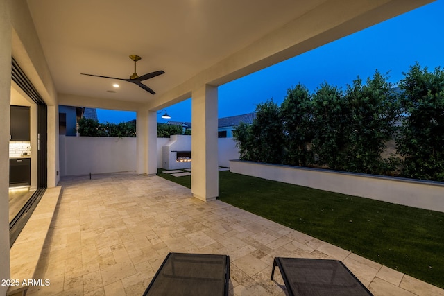 10127 E Tillman Ave, Mesa, AZ 85212 - view of patio with a warm lit fireplace and a ceiling fan