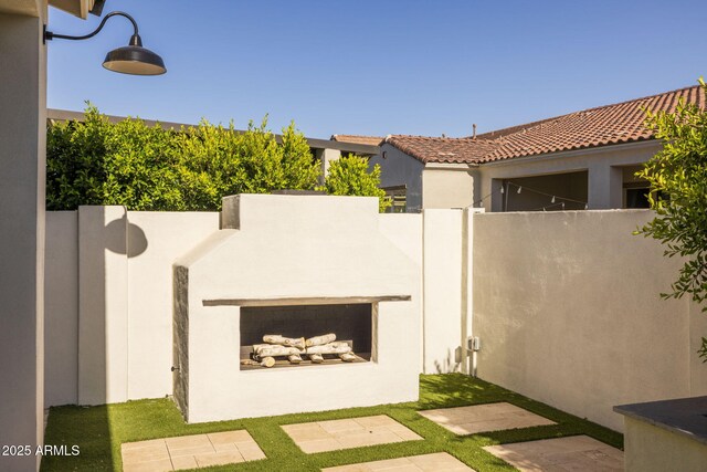 10127 E Tillman Ave, Mesa, AZ 85212 - view of patio / terrace with an outdoor fireplace and fence