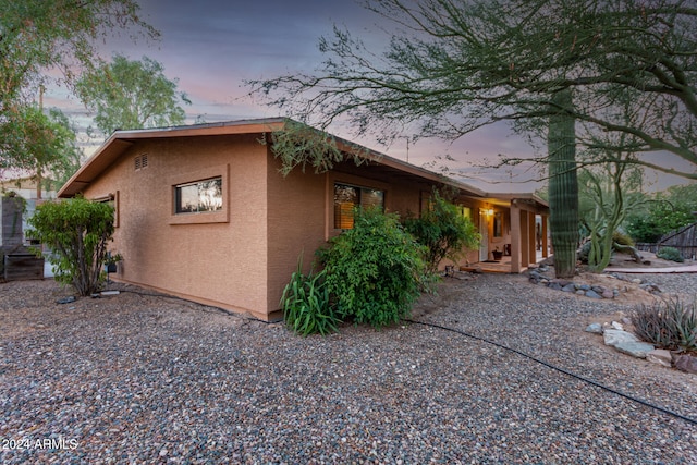 property exterior at dusk with a patio