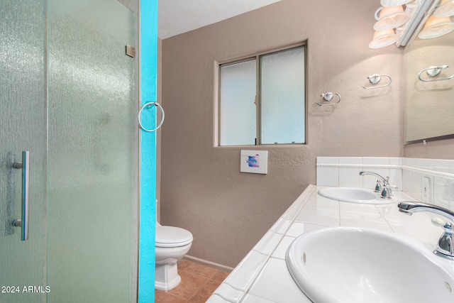 bathroom featuring vanity, toilet, tile patterned floors, and an enclosed shower