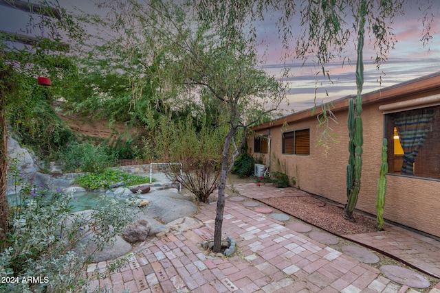 view of patio terrace at dusk