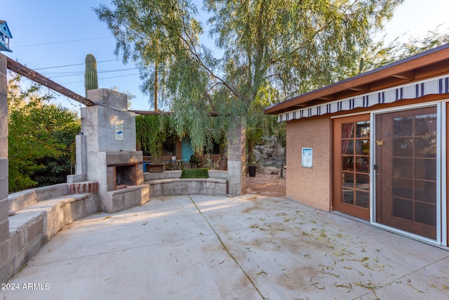 view of patio featuring an outdoor stone fireplace