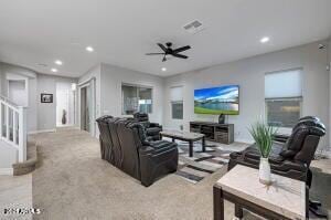 living area featuring recessed lighting, ceiling fan, and stairs