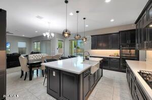 kitchen featuring light tile patterned flooring, a notable chandelier, and light countertops