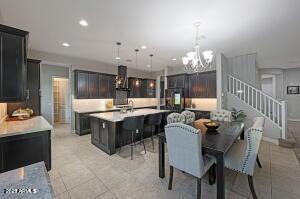 dining space featuring light tile patterned floors, recessed lighting, stairs, and a chandelier