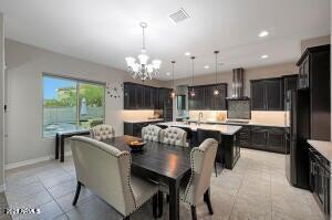 dining space featuring light tile patterned floors, visible vents, baseboards, recessed lighting, and a notable chandelier