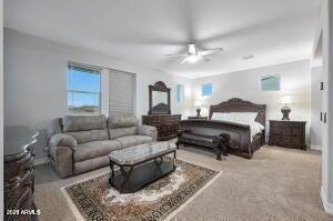 carpeted bedroom with ceiling fan