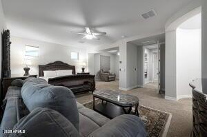 carpeted bedroom featuring ceiling fan and baseboards