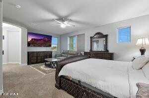 carpeted bedroom with baseboards and ceiling fan