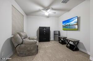 sitting room with a ceiling fan, carpet flooring, baseboards, and visible vents