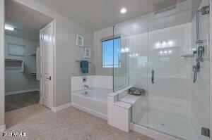 full bathroom with recessed lighting, a bath, a stall shower, and baseboards