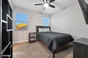 bedroom featuring a ceiling fan, carpet floors, and baseboards