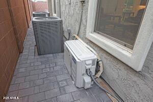 details featuring fence, ac unit, and central air condition unit